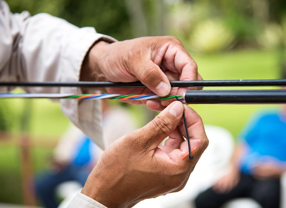 Technician preparing fiber optic cable strands